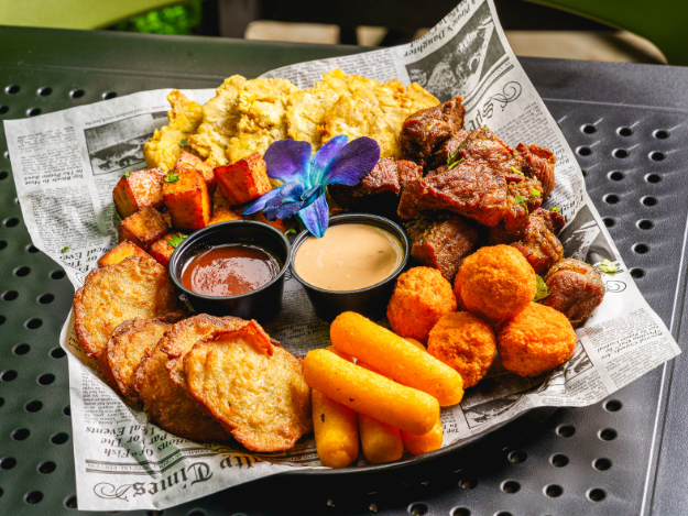 a plate of puerto rican fried street food with a flower in the center