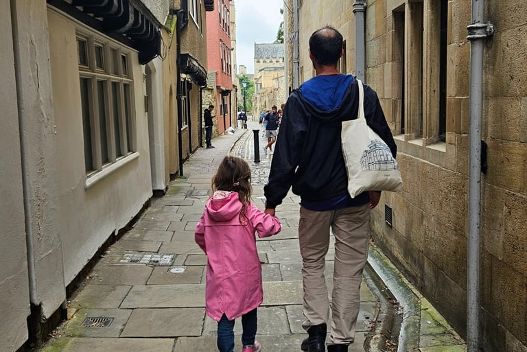 Dad and daughter walking in Oxford after packing rain jackets and a layered capsule wardrobe