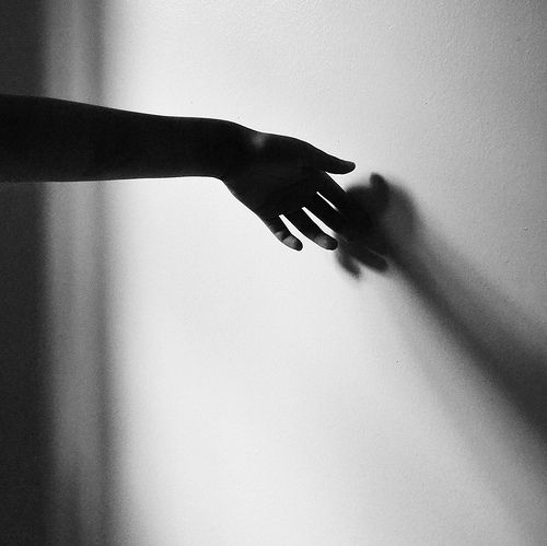 hand on wall casting shadow lvf.lvx black and white photography