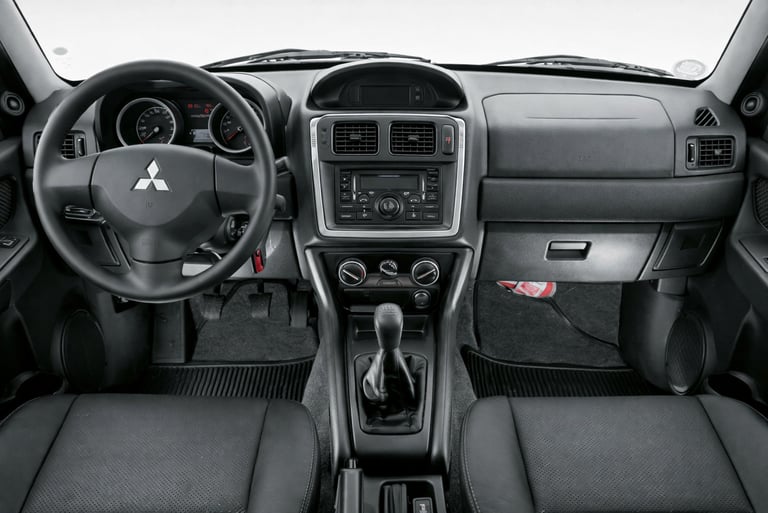 interior da Pajero TR4 4x4 2014 mostrando painel original simples e acabamento funcional do SUV