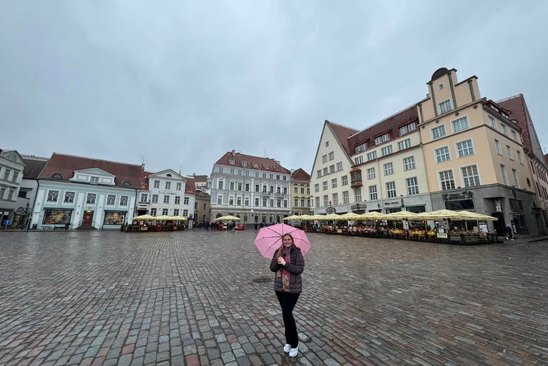 a woman holding a pink umbrella in a medieval town square