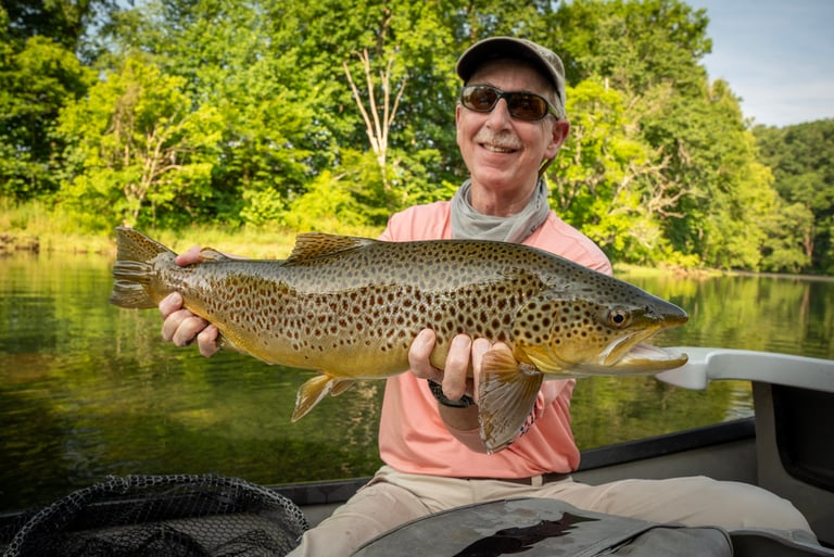 Check out Carl with this monster brown trout he caught on a low water South Holston morning.