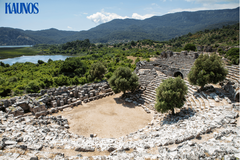 a large stone structure in Kaunos with a lake in the background, best places to visit in Dalyan