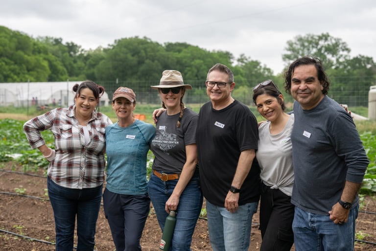 Francisco Gamez stands with his cohort from Leadership Austin at Urban Roots