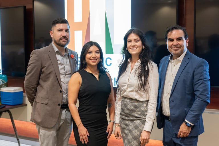 Arnaldo, Claudia, Jenny, and Francisco smile together at a Hispanic Austin Leadership event