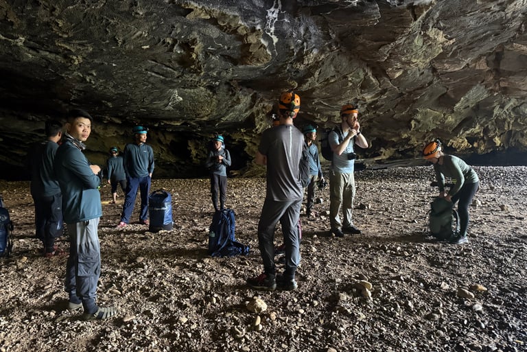 kitting up in the entrance to hang en cave, Ke Bang national park, Vietnam
