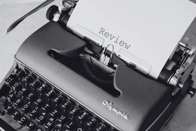 Writing machine with a paper written "review" | review services