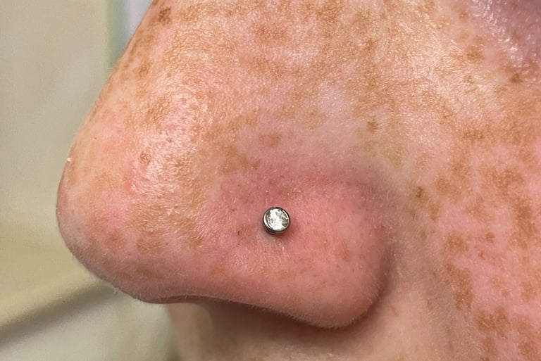 Safe nose piercing with titanium hoop in Montrose