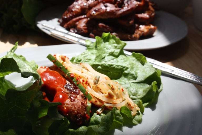 Korean sauce on top of a Korean chicken lettuce wrap