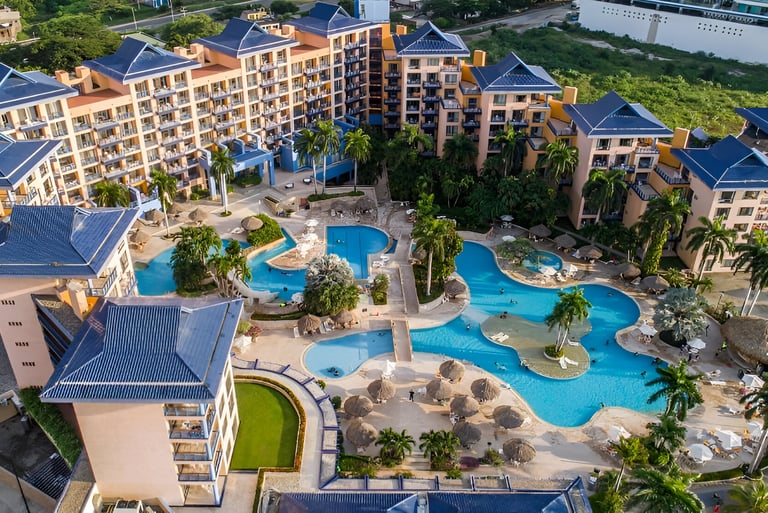a large pool surrounded by hotel rooms at villavicencio