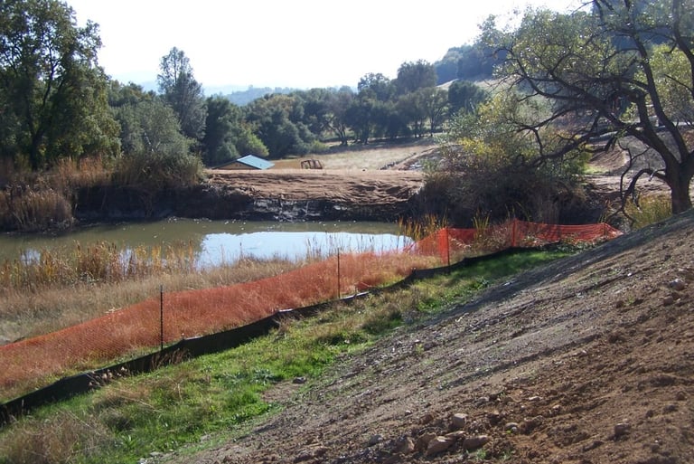 Best management practices in use around a pond and adjacent to construction activities.