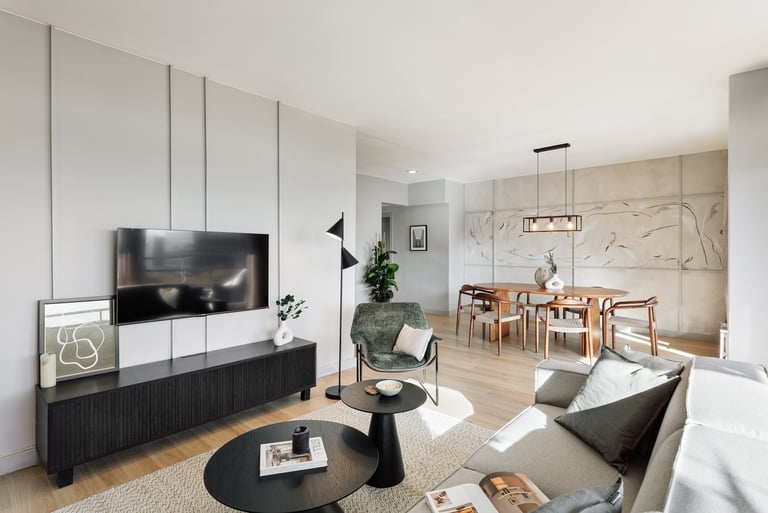 Modern dining area with metal light fixture, wooden dining table, and minimalist interior design