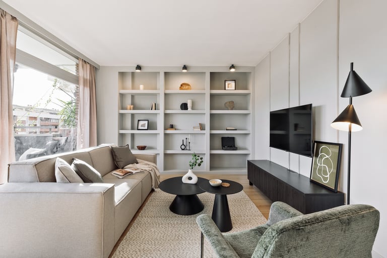 Elegant living room with contemporary furniture, neutral tones and custom bookshelf