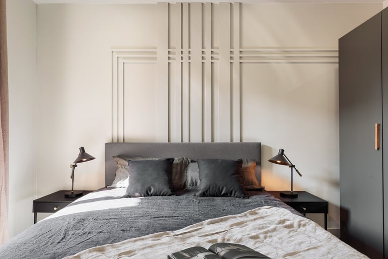 Elegant bedroom with wall panels, calm color palette and modern minimalist design in Barcelona