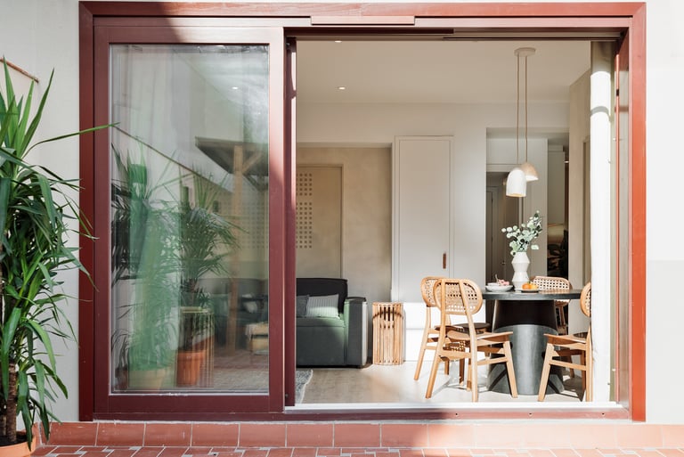 Modern dining area and terrace with sleek design elements and natural wood accents