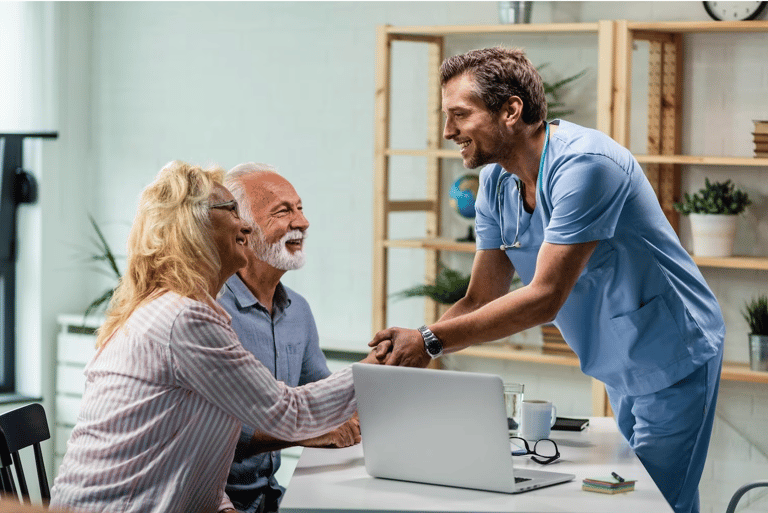 happy senior couple with their doctor