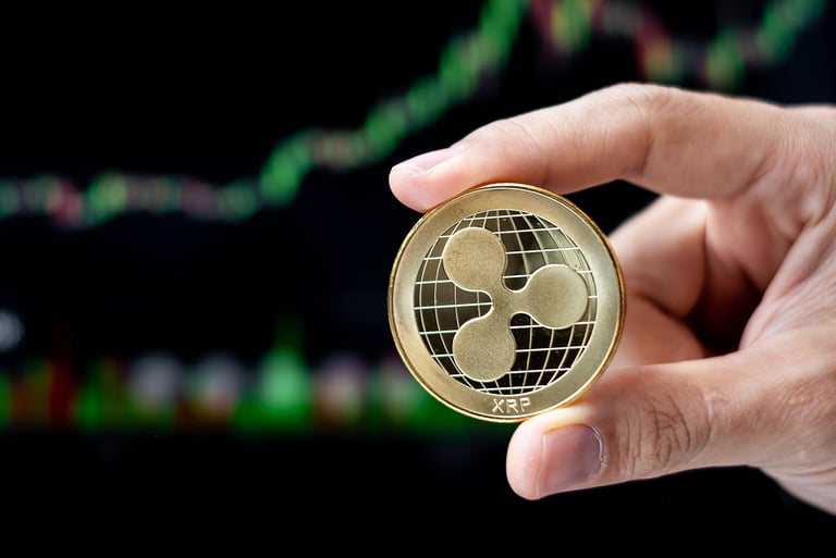 ripple xrp token in someones hands with charts in background