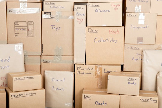 Swift Movers packed boxes showing careful packing of household items like books, dishes, and clothes