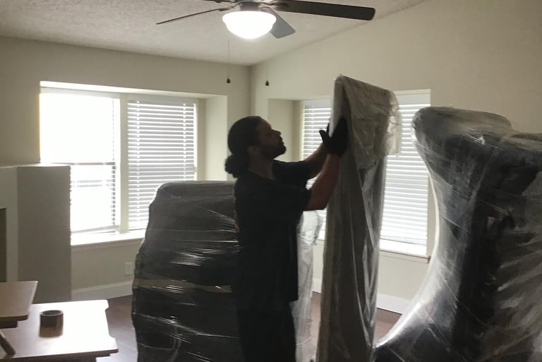 Swift Movers crew wrapping furniture with padding for safe and efficient residential moving