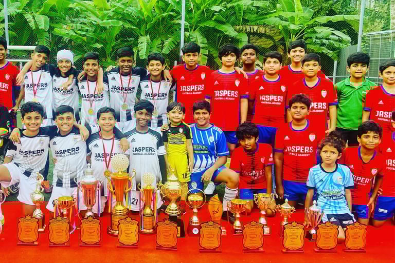 Football coaching camp kids with the trophies they won