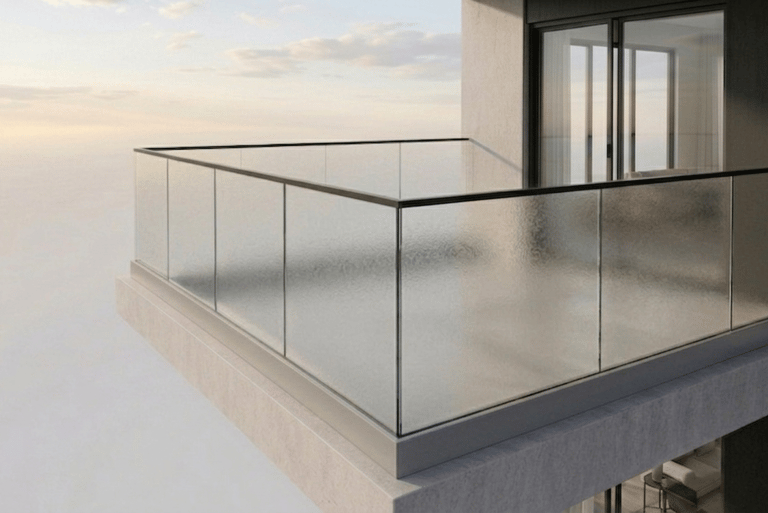 Modern high-rise apartment balcony featuring sleek glass railings and a minimalist concrete design.