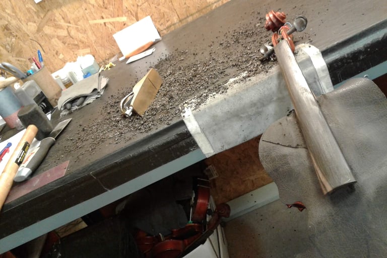Planing a fingerboard to correct shape and fix buzzing.