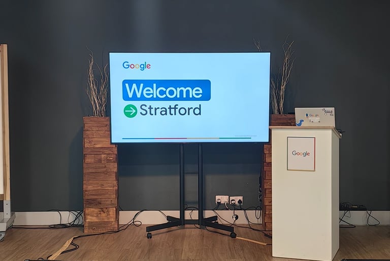 Welcome to Stratford displayed on TV screen in front of the room