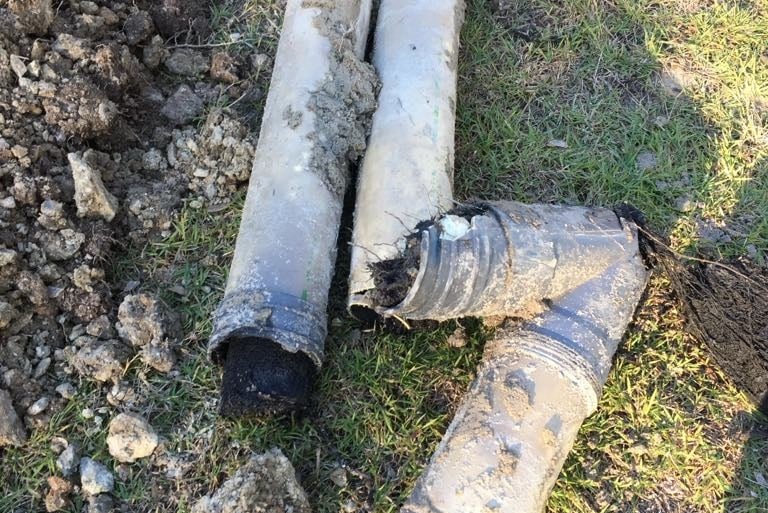 Cracked and broken drain pipes removed during repair of damaged sewer system