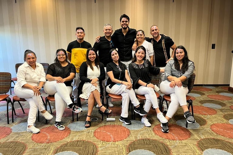 A diverse group of smiling professionals at a corporate team building event posing for a group photo.