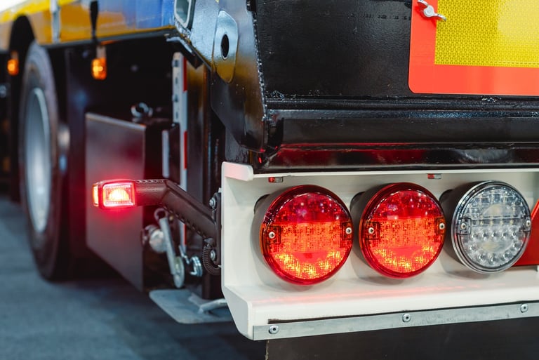 Close-up of red and white LED tail lights on a heavy-duty semi-truck trailer.