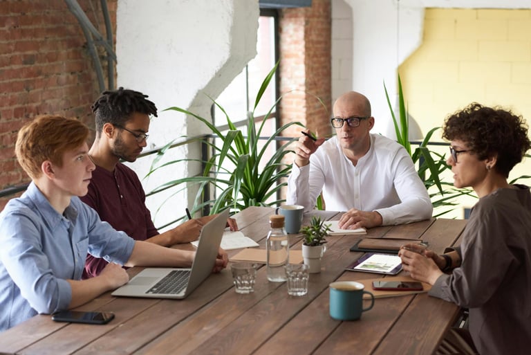 Diverse creative team having a business meeting at a table in a modern office.