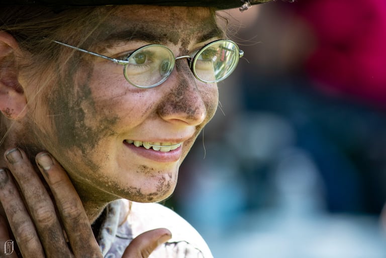 Photo of young woman with dirty face and hands