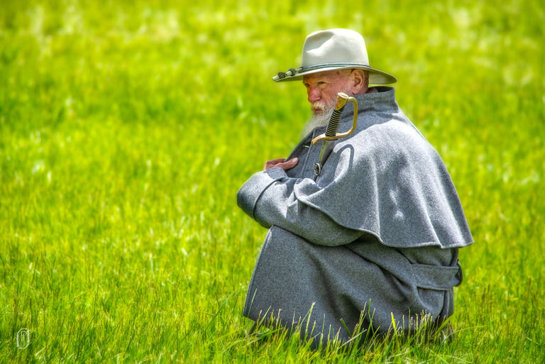 Photo of civil war soldier squating in the grass