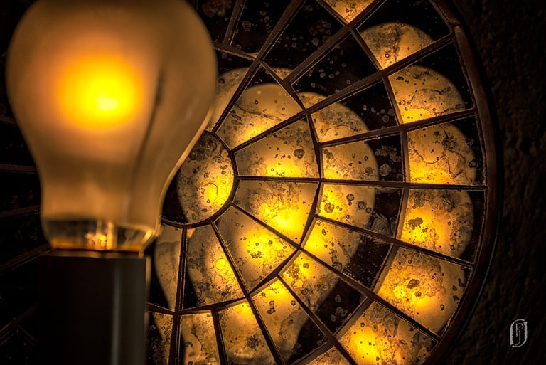 Photo of yellow lightbulb and reflecting disk