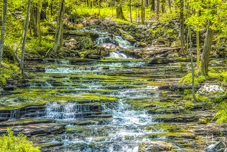 Photo of water falling down cascading rocks