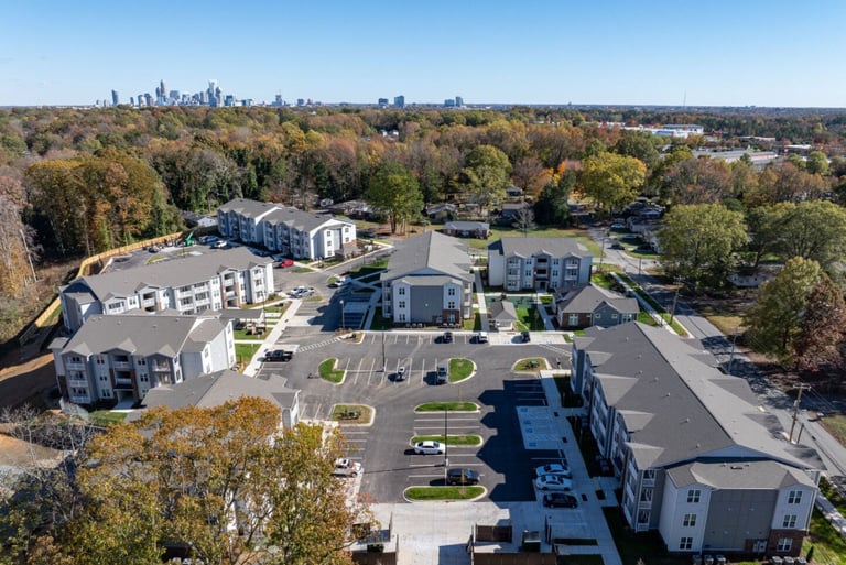 Aerial view of Evoke Living at Morris Field showing completed apartment buildings and parking layout in Charlotte, NC