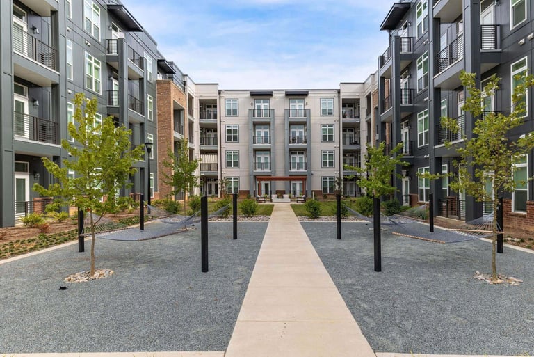 Central courtyard with hammocks between multi-story apartment buildings at Leo Loso in Charlotte, North Carolina.