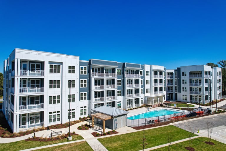 Courtyard pool area surrounded by four-story apartment buildings at a market-rate community in Morehead City, NC.