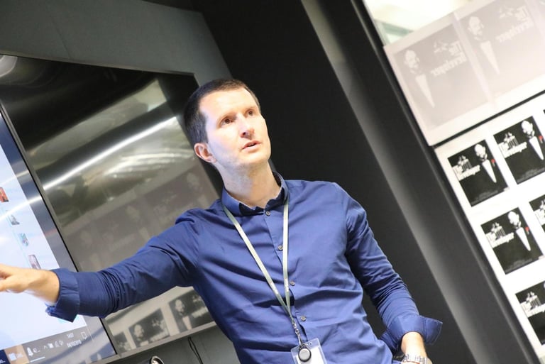 Image of Nick Power presenting an innovation workshop and motioning to the TV screen