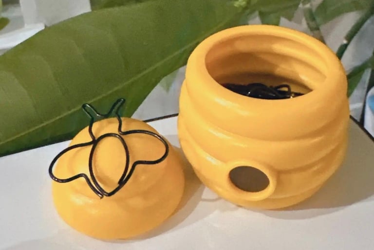 Open bee paper clip holder showing bee-shaped paper clips inside, with magnetic lid for easy access