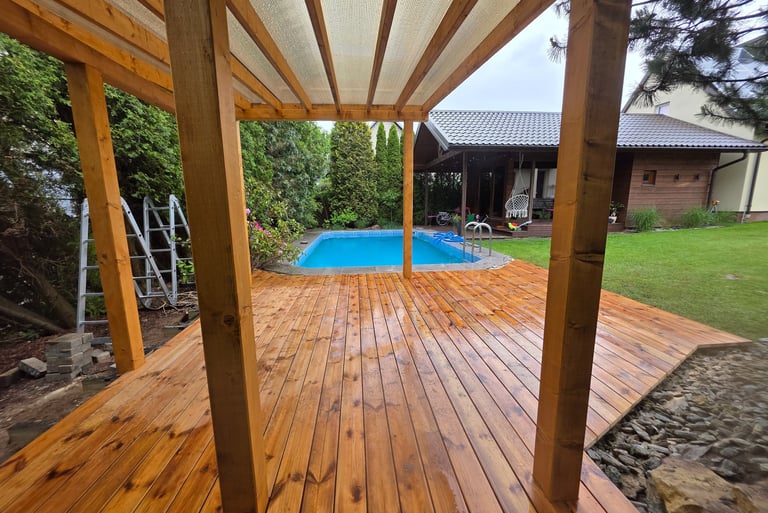 a wooden deck with a pool and a wooden deck