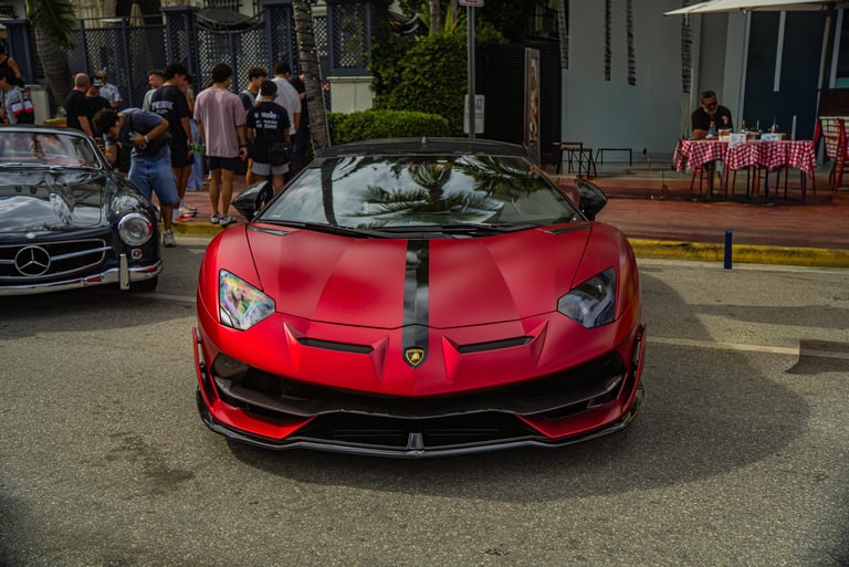 Matte red Lamborghini Aventador SVJ luxury supercar parked on a city street.