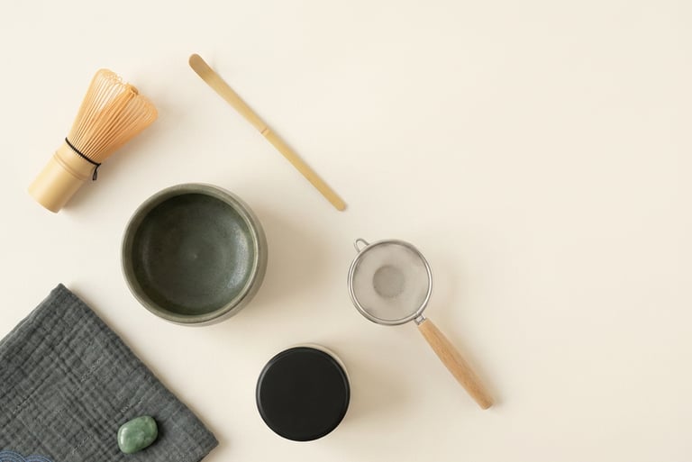 matcha tools arranged chawan chasen chashaku furui natsume chakin on a clear surface