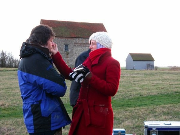 the author doing makeup on a film set