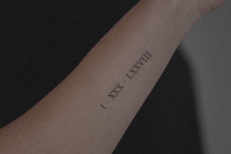 Fine line roman numeral date tattoo on forearm – Sinkply Zürich
