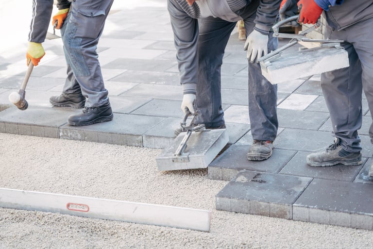 Professional paver installation in progress – Sarasota crew laying stone pavers with precision tools
