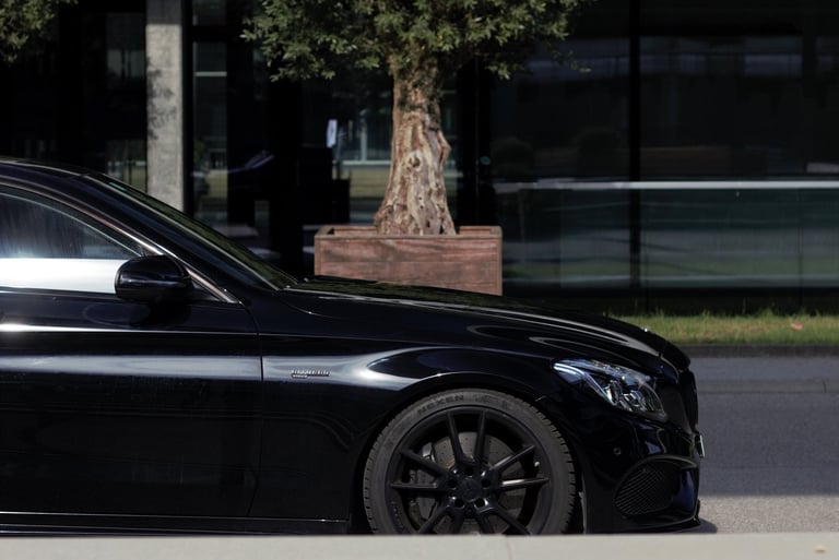 a black car parked on the side of the road