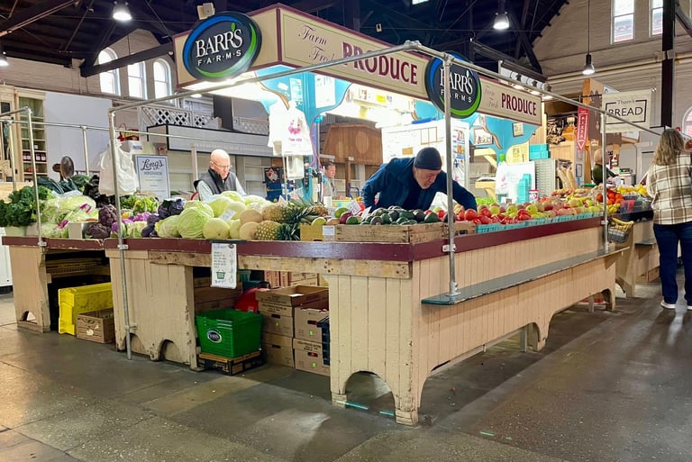 Market vendor arranging produce at a produce stand at Central Market in downtown Lancaster, Pennsylvania