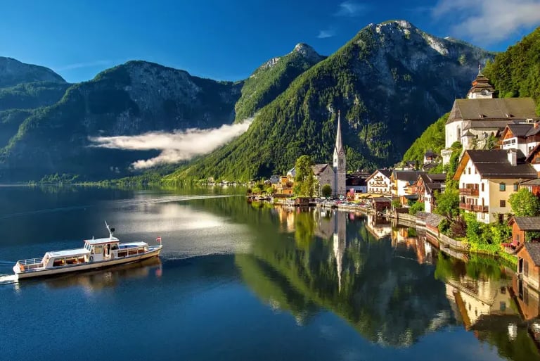 Scenic view of Hallstatt village, Austria, with alpine mountains reflected in Lake Hallstatt.