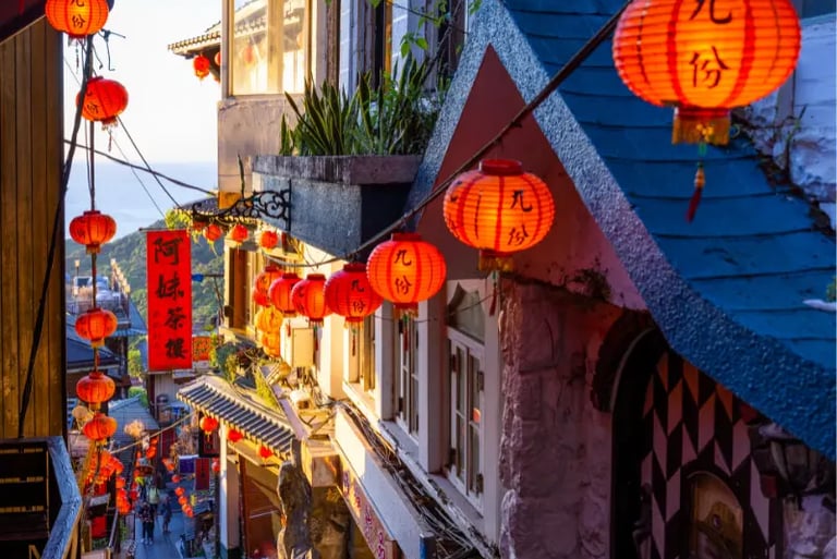 Red paper lanterns glowing along the narrow stone alleys of Jiufen Old Street in Taiwan.